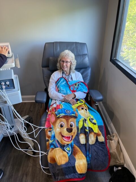 Older patient receiving treatment with blanket